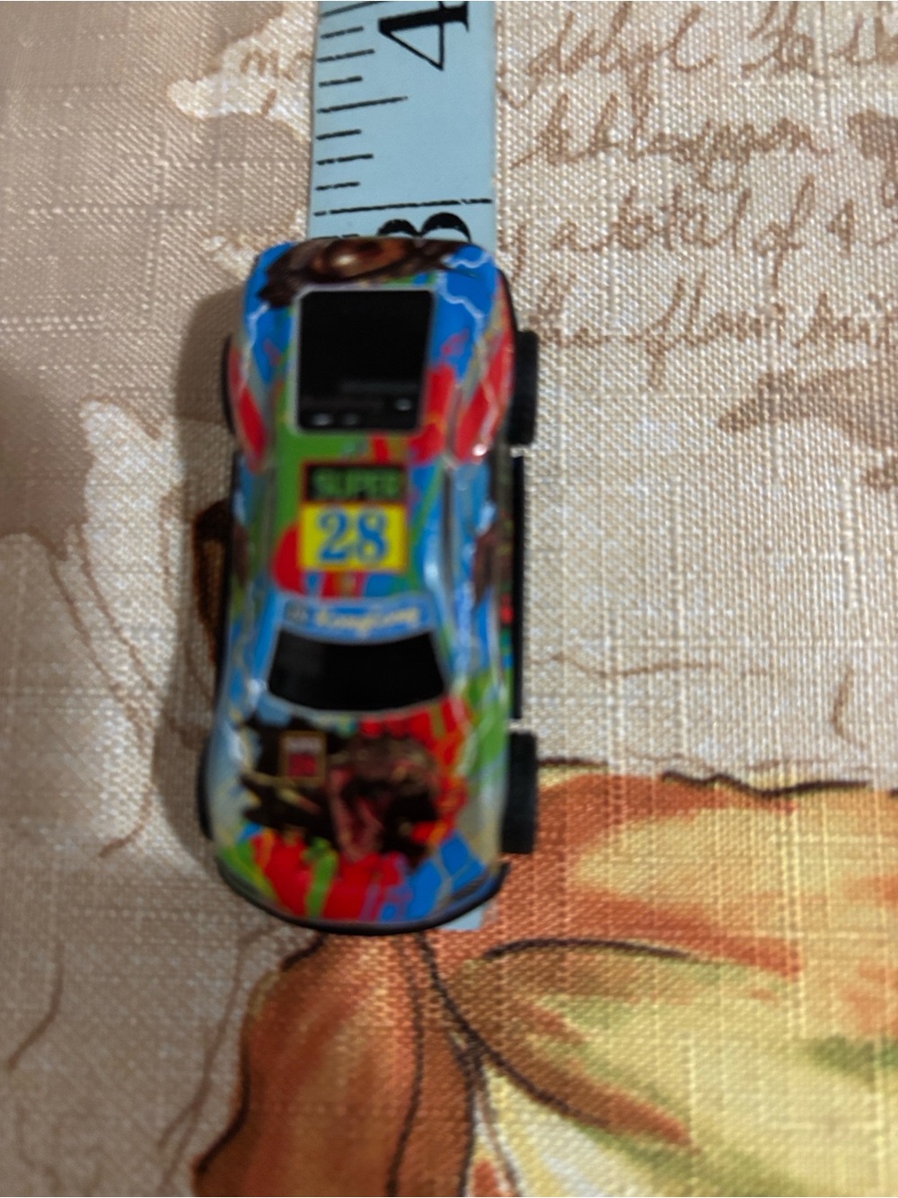 Black Toy Car Bottom View with White Wheels